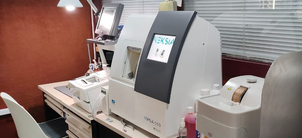 Laboratorio de Óptica Cosmos en Tenerife, con maquinaria moderna como la Neksia 600 para la fabricación y ajuste preciso de gafas personalizadas.